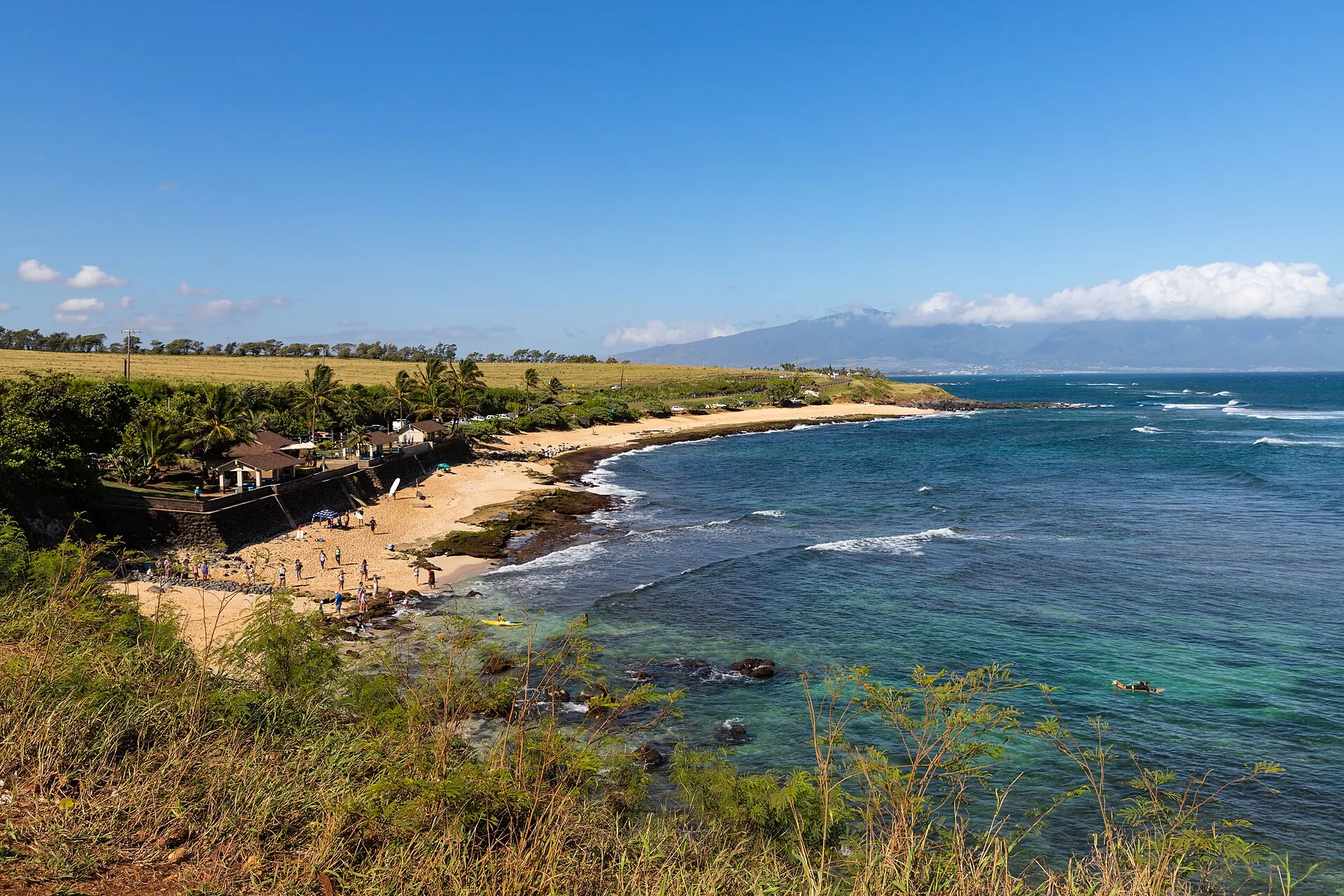 The turquoise bay at Hoʻokipa Beach Park on Maui's North Shore, with the West Maui mountains in the distance